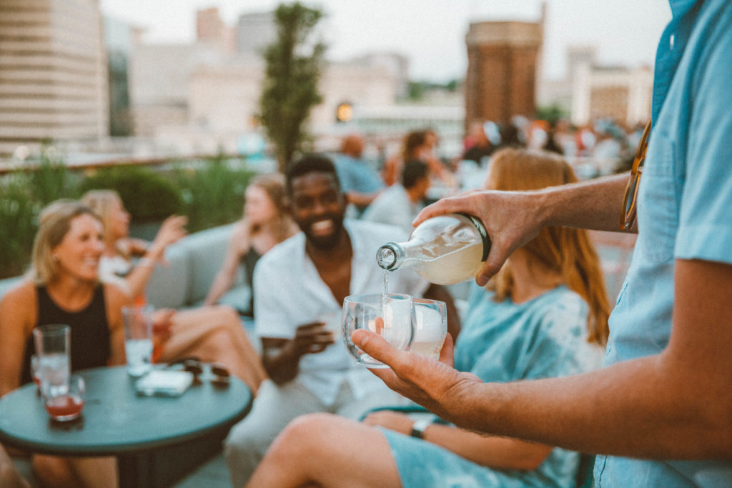 Server pouring drinks for an excited group at our downtown KC hotel