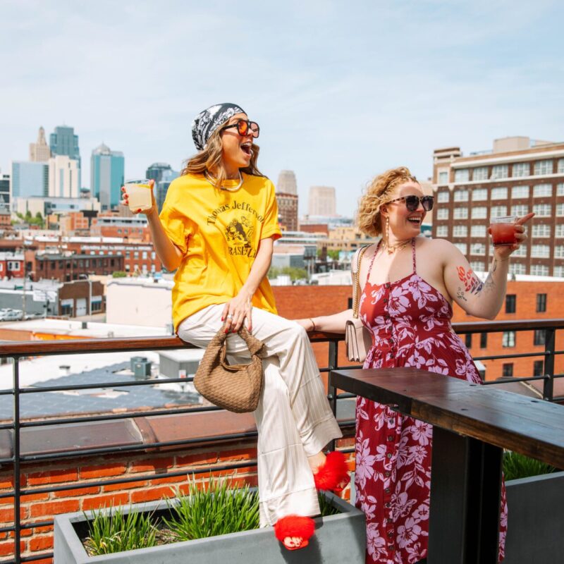 Two women meeting a friend at our rooftop bar in Kansas City, MO