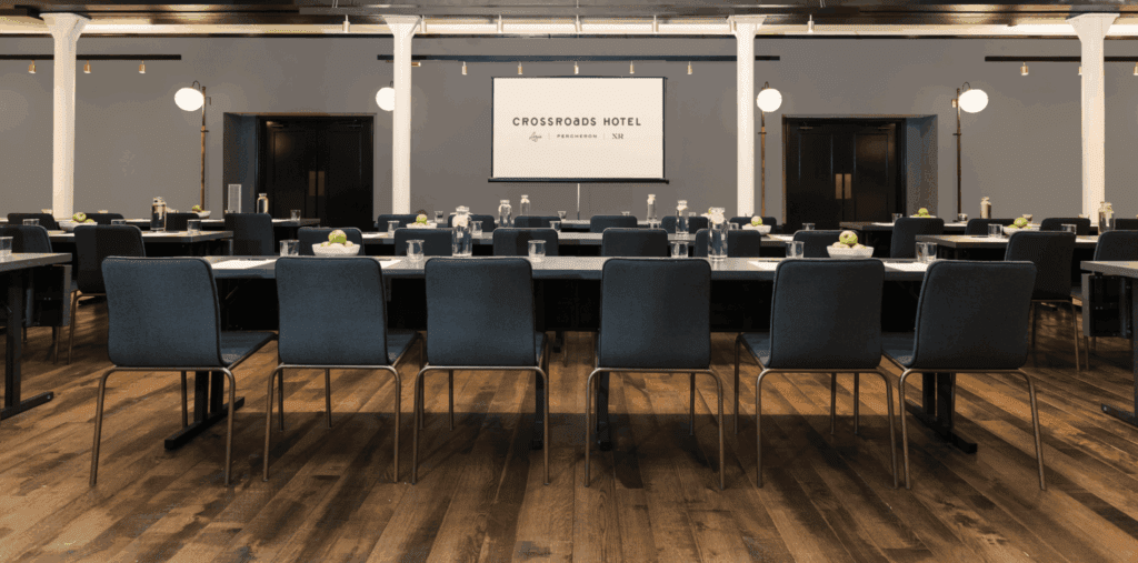 Meeting room full of tables and screen
